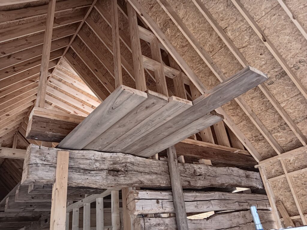 Wooden structure under construction inside a building.