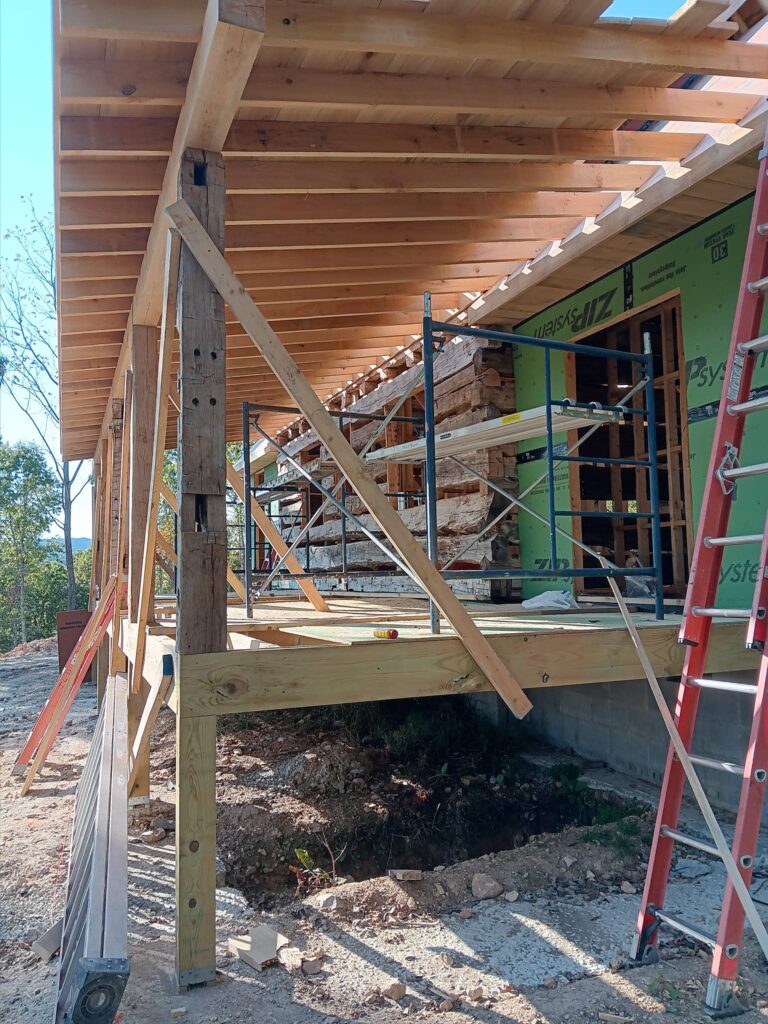 House under construction with scaffolding and ladder