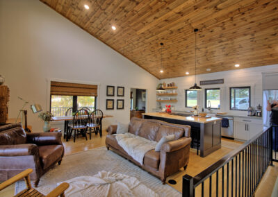 Cozy living room with leather furniture and kitchen.