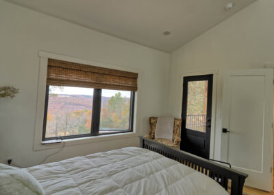 Cozy bedroom with scenic window view.