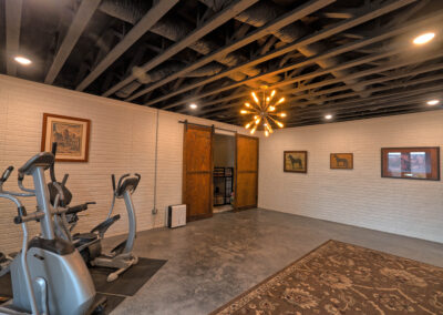 Home gym with equipment and wooden doors