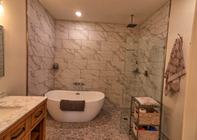 Elegant bathroom with marble tiles and freestanding tub.