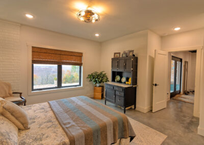 Cozy bedroom with window view and furniture decor.