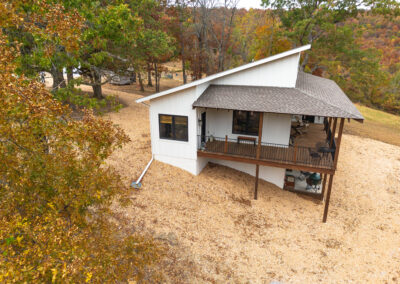 Small cabin surrounded by autumn foliage.