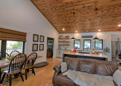 Cozy living room and kitchen with wooden ceiling.